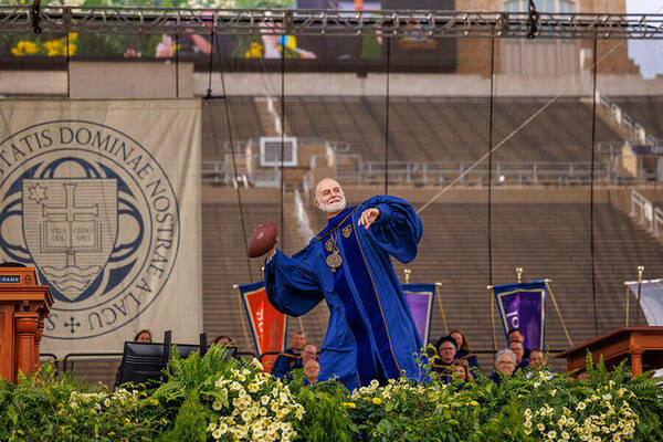 May 15, 2022; Archbishop Borys Gudziak throws a football during his Commencement address. (Photo by Peter Ringenberg/University of Notre Dame)